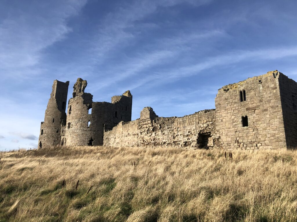 low-angle-view-castle-field-against-sky-1024x768 The Enigmatic Tale of Dunstanburgh Castle: Sir Guy the Seeker and the Sleeping Army